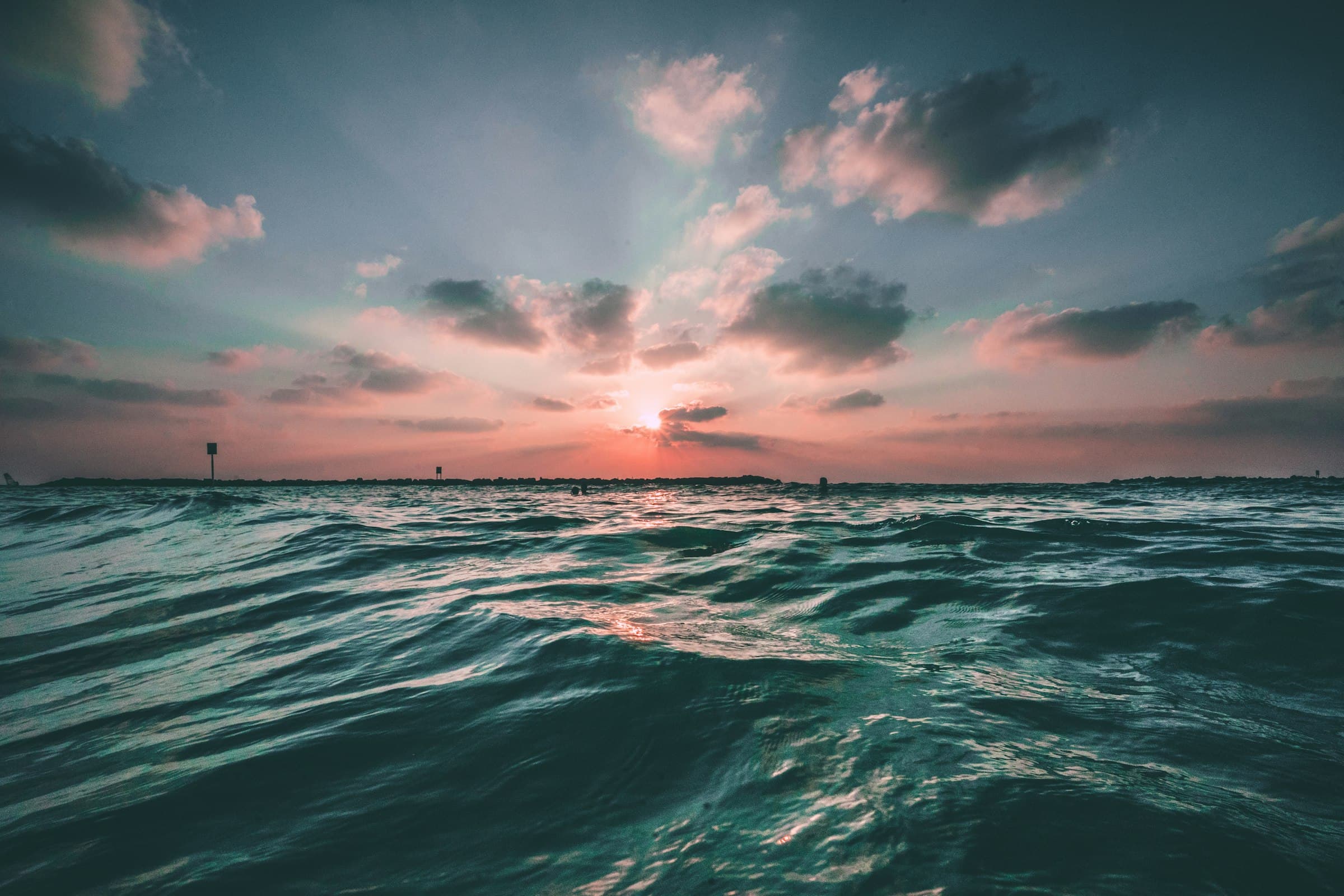 Ocean swell rolling beneath a glowing dusk sky